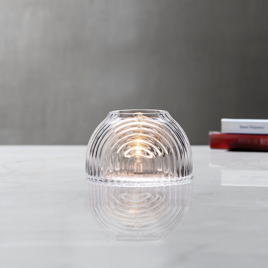 Lead-free crystal dome shaped votive with a rippled design, presented with votive on a table